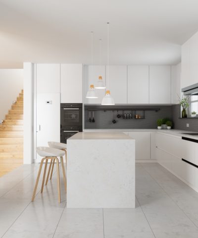 Modern Kitchen Interior With White Cabinets, Kitchen Island, Stools And Staircase In Corridor